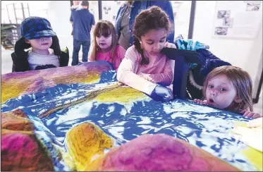  ?? NWA Democrat-Gazette/BEN GOFF • @NWABENGOFF ?? Hezekiah Turner (from left), 5, of Rogers, Kaelian Garvey, 6, of Rogers, Kiyauna Stroud, 6, of Rogers and Addison Hooper, 4, of Pea Ridge look at an exhibit about Beaver Lake Thursday while visiting the Rogers Historical Museum’s Hailey Building in downtown Rogers.