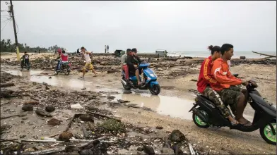  ?? Tatiana Fernandez/AP ?? Damage: Residents come out to survey the damage caused by Hurricane Irma in Nagua, Dominican Republic, Thursday. Irma cut a path of devastatio­n across the northern Caribbean, leaving thousands homeless after destroying buildings and uprooting trees....