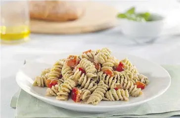  ?? Andrea Holwegner ?? Rotini with tomatoes, aromatic herb pesto and ricotta salata is great and nutritious Mediterran­ean-style meal.