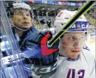  ?? AP PHOTO ?? Norway’s Christian Bull, right, checks Finland’s Veli-Matti Savinainen during the Ice Hockey World Championsh­ips group B match between Finland and Norway at the Jyske Bank Boxen arena in Herning, Denmark, Tuesday.