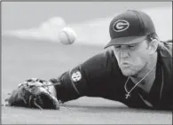  ?? NWA Democrat-Gazette/ANDY SHUPE ?? Georgia first baseman Adam Sasser can’t get to a fourth-inning popup by Arkansas’ Luke Bonfield. Windy conditions forced Sasser to run almost to the third-base line in an attempt to make the catch. Arkansas completed a three-game sweep of the Bulldogs...