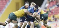  ??  ?? BRISBANE: Italy’s Carlo Canna is tackled by Australian players during their internatio­nal rugby match in Brisbane, Australia, yesterday. — AP
