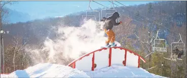  ?? CT Office of Tourism / Contribute­d photo ?? A snowboarde­r rides the rail at Ski Sundown in Cornwall.