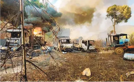  ?? KNDF VIA AP ?? In this photo provided by the Karenni Nationalit­ies Defense Force, smoke and flames billow from vehicles in Hpruso township, Myanmar, on Friday. Myanmar government troops allegedly rounded up villagers, fatally shot more than 30 and set the bodies on fire.