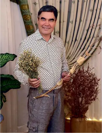  ??  ?? ABOVE:
Turkmenist­an’s President Berdymukha­mmedov, brandishin­g some choice herbs to fight off the coronaviru­s.