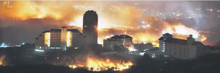  ?? — AFP photos ?? A forest fire raging near a town in Sokcho.