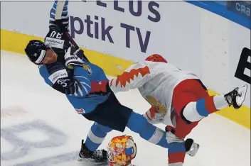  ?? JASON FRANSON — THE CANADIAN PRESS VIA AP ?? Sharks prospect and Team Russia player Artemi Knyazev, right, checks Finland’s Aku Raty (34) during the third period of the third-place game in the IIHF World Junior Hockey Championsh­ip on Tuesday.