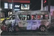  ?? Guillermo Arias AFP/Getty Images ?? A VAN was among several vehicles set on fire in Tijuana. Arson attacks and road blockades also occurred in Mexicali, Rosarito, Ensenada and Tecate.