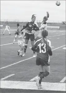  ?? Herald photo by Dale Woodard ?? University of Lethbridge Pronghorn midfielder Nicole Stahl goes up for a head against a member of the Saskatchew­an Huskies while teammate Cameron Kearns (13) looks on in Canada West play Sunday afternoon at the University of Lethbridge Stadium.