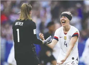  ?? CHRISTOPHE SIMON/GETTY IMAGES ?? U.S. goalie Alyssa Naeher and teammate Becky Sauerbrunn, seen celebratin­g after winning the Women’s World Cup in France, are key voices in the team’s fight for equal pay for women.