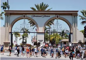  ?? Chris Pizzello/ Associated Press ?? Striking writers and actors take part in a rally on July 14 outside Paramount studios in Los Angeles. California workers on strike could be paid unemployme­nt benefits under a bill lawmakers sent to Gov. Gavin Newsom on Thursday.