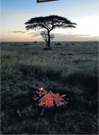 ?? Pictures: Dorria Watt ?? LIFE COALS A view from the campfire at sunset in the Serengeti.