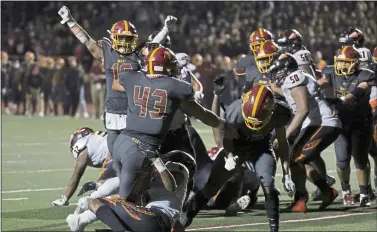  ?? ANDA CHU — STAFF ARCHIVES ?? Menlo-atherton’s Andrew Buck (16) celebrates as teammate Dane Fifita (43) scores a touchdown against Mcclymonds to tie the game 27-27in the fourth quarter of a high school football game in Atherton on Sept. 24.