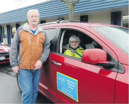  ??  ?? Beacon Community Services medical drive volunteers are among the Beacon team members who are reaching out to isolated seniors on the Saanich Peninsula. Pictured are Patrick McAdams and Wendy Bidgood.