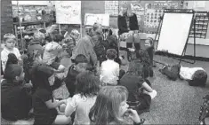  ?? THE ASSOCIATED PRESS FILE PHOTO ?? Elementary school students and their teacher. Retired Hamilton teacher Linda Chenoweth argues in order to make classrooms safer for everyone, problems outside school, such as poverty and housing, need serious attention.