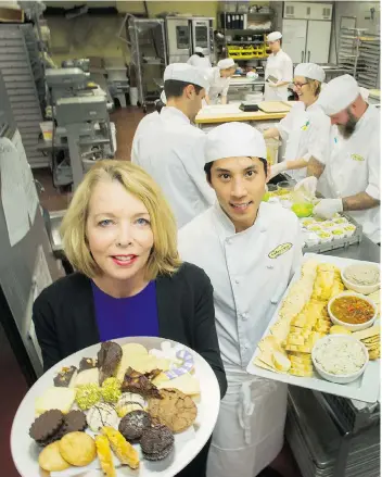  ?? ARLEN REDEKOP/ PNG ?? Debra Lykkemark with chef Dan Chau inside Culinary Capers, one of Vancouver’s top catering companies.