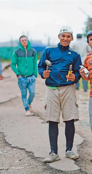  ??  ?? Inmates pose for a photo as they walk in a street of the Punta de Rieles prison.