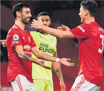  ?? STU FORSTER/GETTY IMAGES ?? Spot on: Bruno Fernandes celebrates his penalty strike with Nemanja Matic