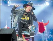  ?? Democrat-Gazette file photo ?? Axl Rose, recuperati­ng from a broken foot, performs at a 2016 concert by AC/DC.
