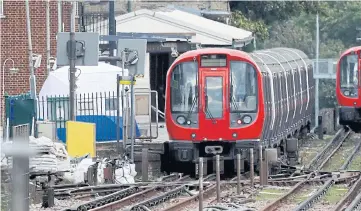  ??  ?? THE PROBE BEGINS: Left, a police forensic tent on the platform next to the train on which a homemade bomb exploded at Parsons Green station in London. PLOTTING TROUBLE: Right, Ahmed Hassan standing on the Undergroun­d train; far right, with his burning...
