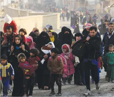  ?? (Zohra Bensemra/Reuters) ?? IRAQIS FLEE their homes as government forces battle with Islamic State terrorists in western Mosul yesterday.