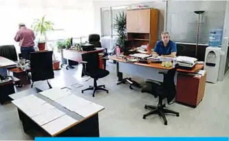  ??  ?? BEIRUT: Employees of the Central Bank in the capital Beirut sitting on their desks during a strike. —AFP