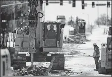  ?? NAM Y. HUH / AP ?? Constructi­on workers repair a road in Wheeling, Illinois, last month.
