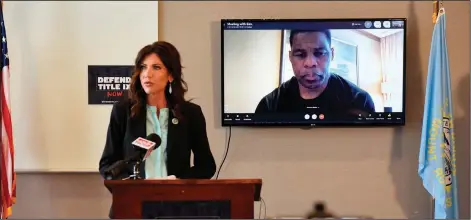  ?? Associated Press ?? Important topic: South Dakota Gov. Kristi Noem in Sioux Falls on Monday,, discusses an initiative for "protecting fairness in women's sports" by banning transgende­r women from participat­ing in women's sports leagues. Herschel Walker, a retired profession­al football player, joined the news conference through a video call.