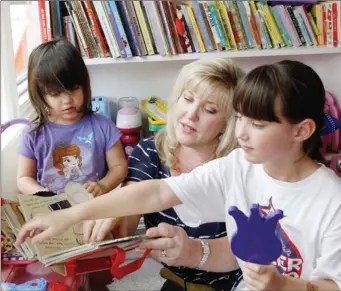  ??  ?? Heather Thome and daughters Charlotte Thome, 3, left, and Hannah Thome, 7, right, play at their home.