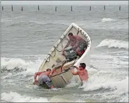  ?? ALEX BRANDON/AP PHOTO ?? Fishermen launch a boat as they attempt to recover their fishing net Thursday in Virginia Beach, Va., as Hurricane Florence moves toward the eastern shore.