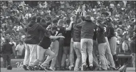  ?? The Associated Press ?? DIVISION CHAMPS: Milwaukee Brewers players celebrate after defeating the Chicago Cubs, 3-1, Monday in Chicago. The two teams were tied atop the National League Central, and the win gave the division title to the Brewers.