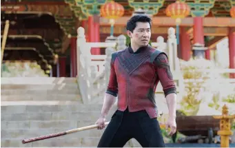  ?? Marvel studios ?? CARRYING A BIG STICK: Simu Liu portrays Shang-Chi in Marvel Studios’ ‘Shang-Chi and the Legend of the Ten Rings,’ which stayed on top at the box office, with $35.8 million in its second weekend.