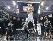  ?? GASH/THE ASSOCIATED PRESS] [MORRY ?? Milwaukee Bucks’ Giannis Antetokoun­mpo dunks during the first half of Game 4 of an NBA first-round playoff series against the Boston Celtics on Sunday in Milwaukee.