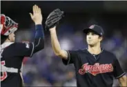  ?? FRANK GUNN — THE ASSOCIATED PRESS ?? Cleveland Indians starting pitcher Ryan Merritt, right, celebrates with catcher Roberto Perez after an inningendi­ng double play against the Toronto Blue Jays on Wednesday.