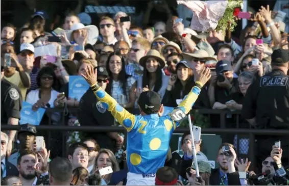  ?? PHOTOS BY THE ASSOCIATED PRESS ?? Victor Espinoza reacts to the crowd after guiding American Pharoah to win the 147th running of the Belmont Stakes horse race at Belmont Park, Saturday, June 6, 2015, in Elmont, N.Y. American Pharoah was the first horse to win the Triple Crown since...