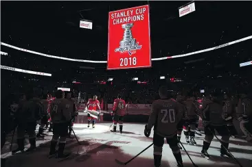  ?? — GETTY IMAGES ?? Alex Ovechkin of the Capitals holds the Stanley Cup before watching the 2018 Stanley Cup Championsh­ip banner rise on Wednesday in Washington, DC.