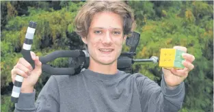  ?? JASON MALLOY ?? Annapolis Royal’s Saul Hafting has set a Guinness World Record for most rotating puzzle cubes (commonly known as a Rubik’s Cube) solved while on a pogo stick.