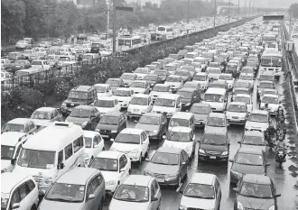  ??  ?? Vehicles jam a thoroughfa­re in New Delhi, India. Helen Currie, chief economist at ConocoPhil­lips, says, “We really tend to see oil demand being fairly strong and robust.”