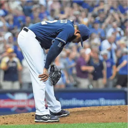  ?? BENNY SIEU / USA TODAY SPORTS ?? Brewers pitcher Jeremy Jeffress agonizes over a save in the ninth inning Thursday night at Miller Park. Javier Baez singled to center to score Ian Happ and tie the score, 3-3.