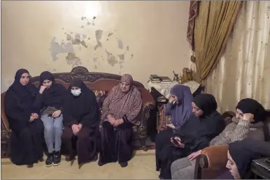  ?? AP photo ?? (third left) the mother of Omar Seif who was killed over the weekend in Iraq sits in her apartment surrounded by friends and relatives who came to pay condolence­s for her, in the northern Lebanese village of Wadi Nahleh, Lebanon on Wednesday. As Lebanon slid deeper into economic misery over recent months, dozens of young men have disappeare­d from the country’s marginaliz­ed north and later surfaced in Iraq, where they are believed to have joined the Islamic State group. The migration has stoked fears of a new wave of radical recruitmen­t, taking advantage of frustratio­n and despair fueled by the economic meltdown and sectarian tensions.