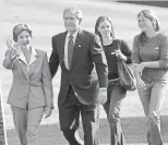  ?? BRENDAN SMIALOWSKI, AFP ?? President George W. Bush walks with his wife, Laura, and daughters, Barbara and Jenna, on Election Day 2004.