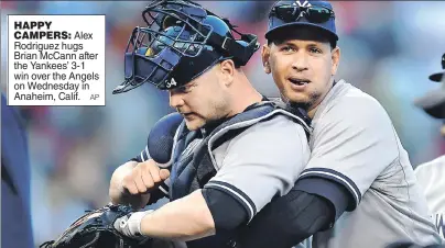  ??  ?? HAPPY CAMPERS: Alex Rodriguez hugs Brian McCann after the Yankees’ 3-1 win over the Angels on Wednesday in Anaheim, Calif.