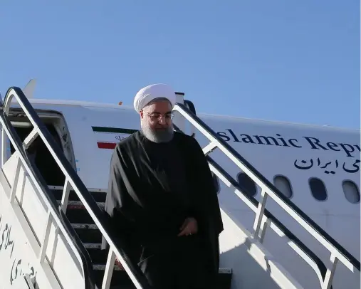  ?? (Reuters) ?? IRANIAN PRESIDENT Hassan Rouhani walks down aircraft steps as he arrives at Kermanshah near the areas worst hit by the earthquake.