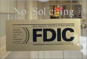  ?? PETER MORGAN — THE ASSOCIATED PRESS ?? An FDIC sign is posted on a window at a Silicon Valley Bank branch in Wellesley on Saturday.