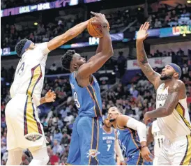  ?? [AP PHOTO] ?? New Orleans Pelicans forward Anthony Davis blocks a shot by Oklahoma City Thunder forward Jerami Grant as center DeMarcus Cousins lifts his hand.