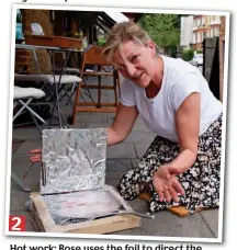  ??  ?? Hot work: Rose uses the foil to direct the heat on to the frying pan under the clingfilm