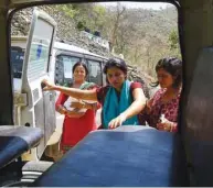  ??  ?? Nepali mother Pabitra Dhungel, centre, getting into an ambulance a day after giving birth, at a health centre in the Ramechhap district, some 100kms east of Kathmandu.