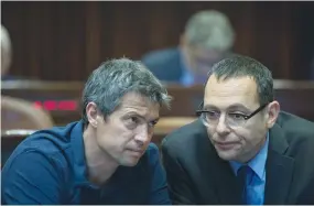  ??  ?? DERECH ERETZ Party MKs Yoaz Hendel ( left) and Zvi Hauser confer in the Knesset Plenary Hall in April 2019. ( Noam Revkin Fenton/ Flash90)