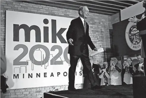  ?? JIM MONE/AP ?? Democratic presidenti­al candidate Michael Bloomberg meets with campaign workers and supporters in Minneapoli­s on Thursday as he opens the first field office in Minnesota, which is a Super Tuesday state. The former New York mayor is focusing on the Super Tuesday primaries that decide 40% of party convention delegates.