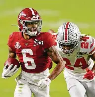  ?? Sam Greenwood / Getty Images ?? Heisman winner DeVonta Smith had 12 catches for 215 yards and three TDs — all in the first half — to help Alabama take a 35-17 lead.